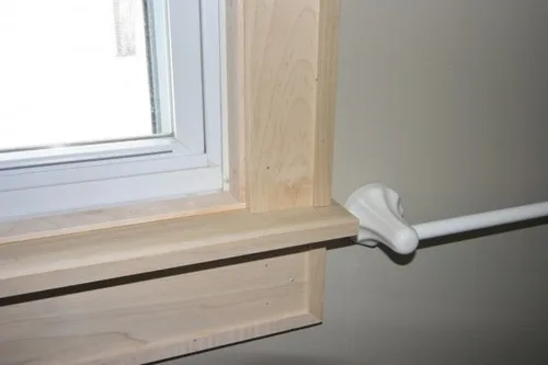 **Defenestration?**

I’ve spent a great many hours over the last week working on my biggest projects yet: window trim. I’ve learned a lot (and purchased a great many tools).  
  

Here’s where we started. As you can see, they have no trim and there is a marble sill. All in all, I’m reminded of the cheap apartment I lived in during college. We’re planning on painting soon, so we decided to add trim first. I started in the master bath because we’re not using it much, so if the project went horribly we could just seal it off and pretend it never happened.  
  
My father helped me come up with a plan. Our house doesn’t have much in the way of trim now, so we were starting with a blank slate: we’ll use the same pattern throughout the house eventually. We decided on a design that will provide some shadow lines but will be simple-looking enough to go with the house’s modern exterior. We chose to use poplar because we intend to paint– we didn’t want a wood with a lot of grain.

  
Here’s the finished product. The side casings are 1x4 and the head casing and apron are 1x6. The back band is 2x2 rabbeted into an L-shape and then trimmed down to ¾ in on the front face and coped to the wall. Originally, we had no back band, a 1x8 head casing, and I planned to install strips of molding at the top of the cap and under the apron. The intent was to make the ceiling look taller, but it was just too much, especially for a tiny bathroom.  
  
I’m delighted with how the window turned out. I still need to fill in the nail holes, sand, and prepare the window for painting. We have two windows to do in our bedroom. I’ll start those just as soon as I figure out how to cram 8 ft boards into the Golf.