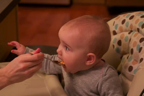 **Yum! What a good eater!**

We say that over and over again.  It used to be that we were offering praise in hopes that she’d take one more bite of rice cereal or stage one baby food, but now it’s a true declaration after she enthusiastically accepts her next bite of big people food.  Abigail loves flavorful food.  Forget about baby food.  She wants the good stuff.  As of today, her favorites include: bananas, guacamole, the meat sauce from spaghetti and meatballs, and chicken makhani.  Yes, our girl loves Indian food!