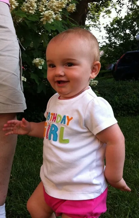 **One year!**

It’s already been one year, and I can’t believe it!  My how our girl has grown!  I keep saying to John “we really need to write that down” and so here I am.    
  
Here are some accomplishments from her first year. As of today, Abigail says Abigail, baby, kitty, hi, hey, bye, pappa (her current favorite word), and mamma.  She also understands a ton of words and sentences.  She grabs my hand when I say “let’s go to the kitchen” or “let’s go to mamma and pappa’s room.”  She will retrieve toys when we say “go get Elmo” or will bring toys to someone when we say “take this toy to.”  It seems like such a small thing, but it’s pretty amazing how much she understands.  She’s constantly learning new things.  It now frequently takes only one explanation and she has something figured out.  For example, I showed her once how to open someone’s cell phone the other day, and she promptly did it herself.  Another thing to add to her list of accomplishments. ;)    
  
Now about “accomplishments” from the past year.  These are all milestones that I want to remember: napped in her crib for the first time at 4 months, first tooth at 4.5 months (8 teeth at 1 year, and cutting another one now), first solids (rice cereal) at 5 months, rolling around to get places around 6 months, pulling self up at 6.5 months, crawling around 7 months, first steps at 8.5 months, and  walking before 11 months.  Hopefully, I can add sleeping through the night to this list soon.  I can’t seem to remember right now when she said her first word.  I remember that it was “Ma” though.  (For awhile that’s what she said when she wanted something from me.  I’d wake up in the middle of the night to crying and Ma.  That’s when I knew mamma would be doing the nighttime parenting for some time.)    
  
So anyway, our girl is one now.  She’s a 30” long, 24 pound bundle of activity, and we’re loving every bit.