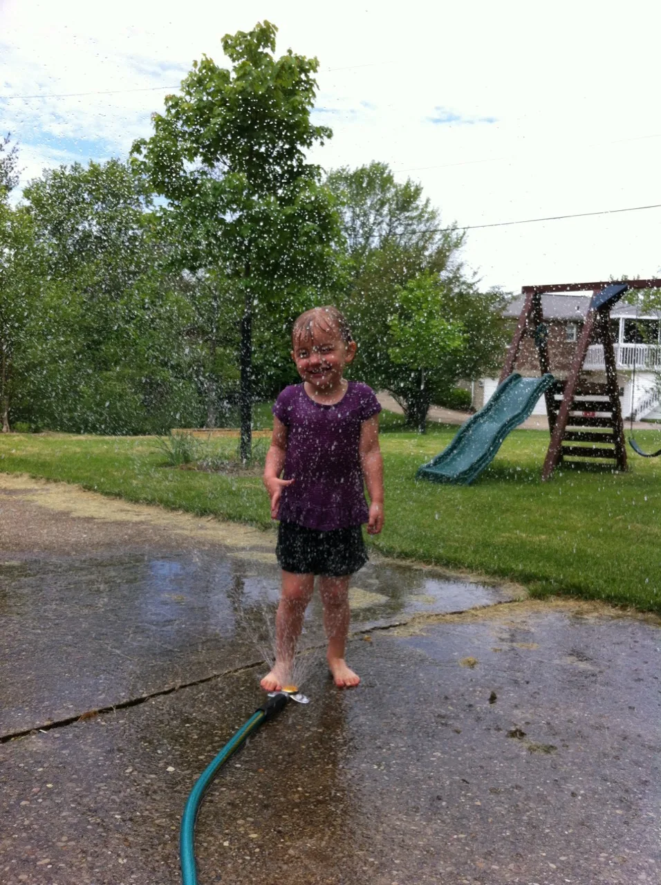 With a little help, Abby planted seven tomato plants and one red bell pepper plant in her garden today. Afterwards, she rewarded her hard work with a run through the sprinkler.