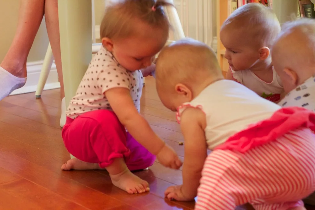 Babies! Babies! Babies! The scene at our house today. Four babies (two sets of nine month old twins) crawling around the kitchen floor hunting for Cheerios. It was a pretty amazing sight.