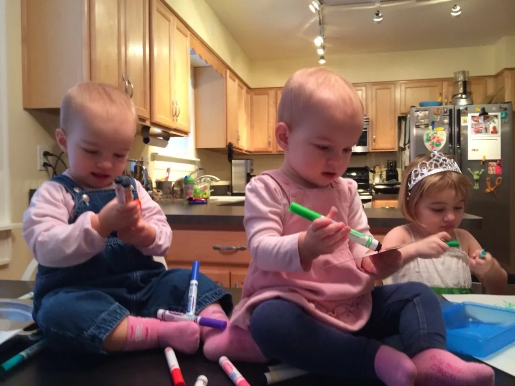 Fifteen months old today and already budding artists. If only someone would take the tops off the markers.