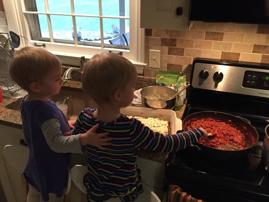A couple of pals helping Papa make lasagna.
