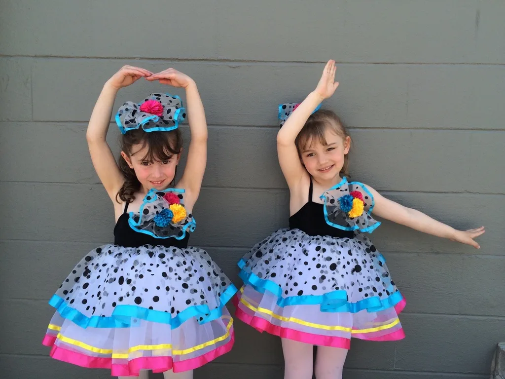 Two best friends trying out their recital costumes at dance class picture day today.