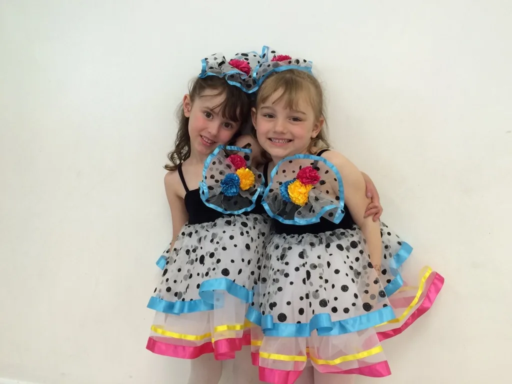 Two best friends trying out their recital costumes at dance class picture day today.