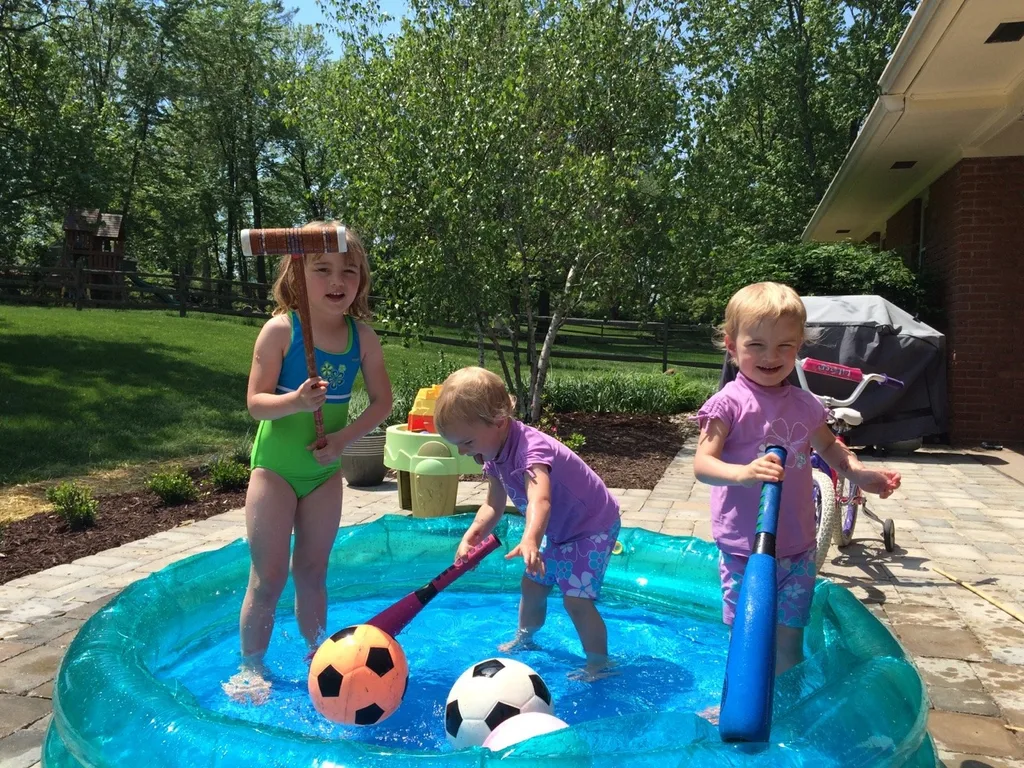 It felt like summer today! We got all hot and sweaty with a Madeira Moms playgroup at the new Blue Ash Summit Park. The girls enjoying playing on the awesome (albeit sun-drenched) play structure, swinging on the over-sized porch swings, and doing “tricks” on the great lawn. They capped off the fun by cooling off in their backyard pool. I hope they take great naps because all that sun and excitement sure wore me out!