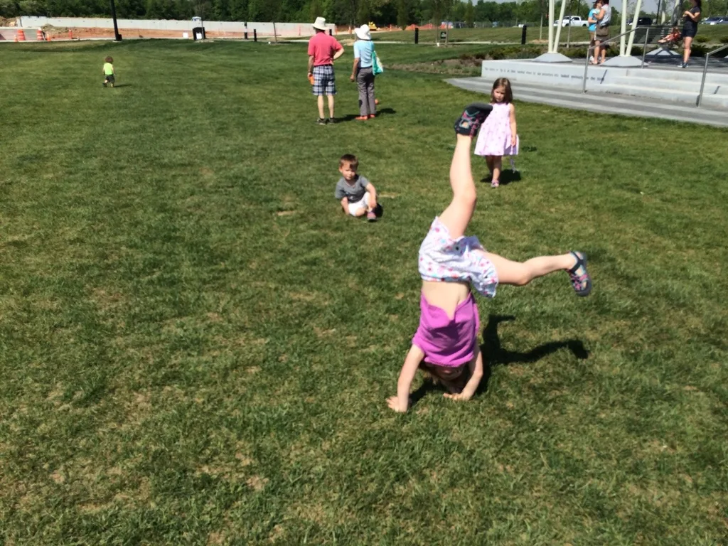It felt like summer today! We got all hot and sweaty with a Madeira Moms playgroup at the new Blue Ash Summit Park. The girls enjoying playing on the awesome (albeit sun-drenched) play structure, swinging on the over-sized porch swings, and doing “tricks” on the great lawn. They capped off the fun by cooling off in their backyard pool. I hope they take great naps because all that sun and excitement sure wore me out!