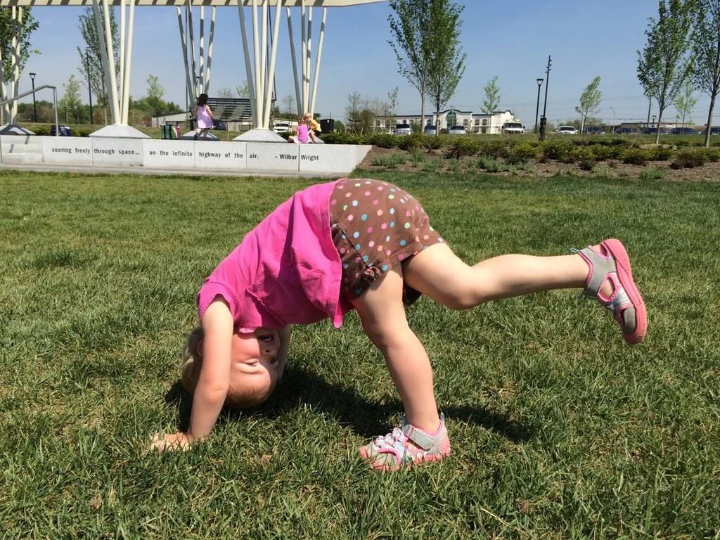 It felt like summer today! We got all hot and sweaty with a Madeira Moms playgroup at the new Blue Ash Summit Park. The girls enjoying playing on the awesome (albeit sun-drenched) play structure, swinging on the over-sized porch swings, and doing “tricks” on the great lawn. They capped off the fun by cooling off in their backyard pool. I hope they take great naps because all that sun and excitement sure wore me out!