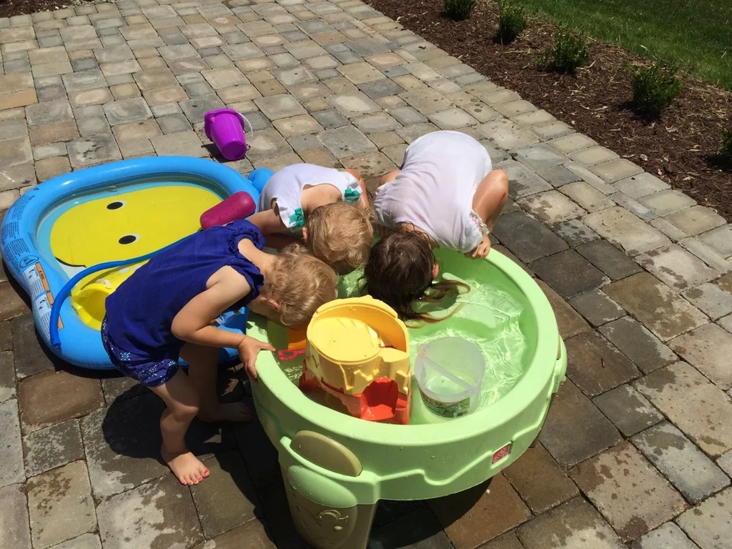 Three silly girls soaking their faces like they’re bobbing for apples.