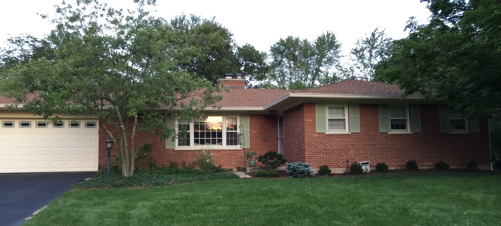 Tan and red no longer! We’re very pleased with our refurbished and repainted shutters. (We also removed the odd little window boxes.)