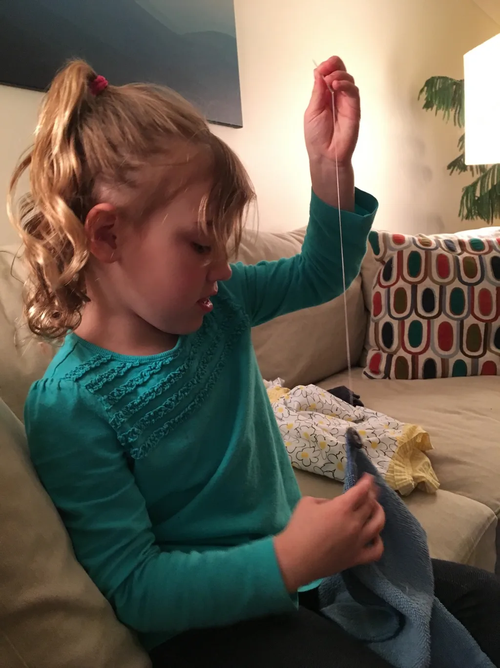 First she wanted me to teach her to sew on a button, and then she decided to help her Papa. Abby is a curious girl with many talents!