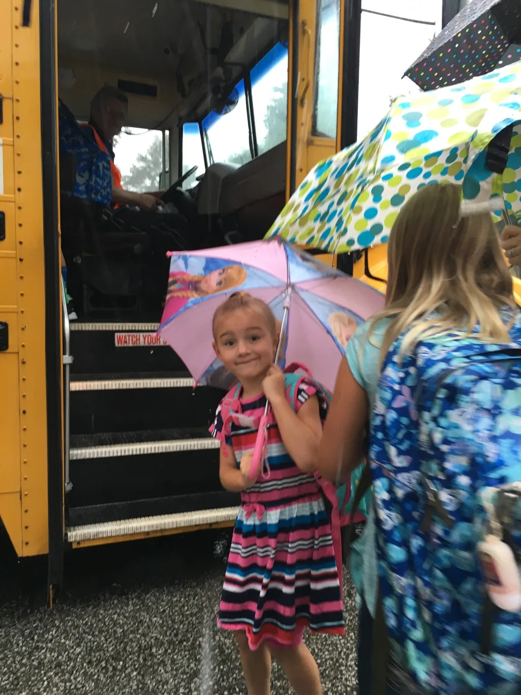 First day of first grade! Even the pouring rain couldn’t put a damper on the excitement at the bus stop this morning.