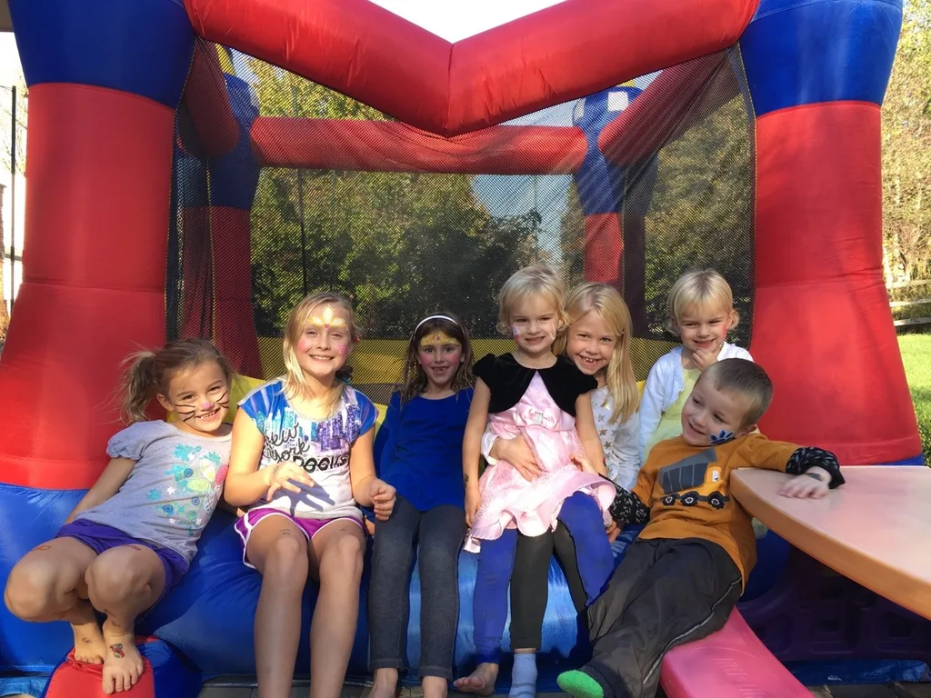 Take lots of bouncing friends, brush on some face paint, press on some tattoos, mix in a craft, eat lots of cupcakes and ice cream, and you end up with two very happy birthday girls!