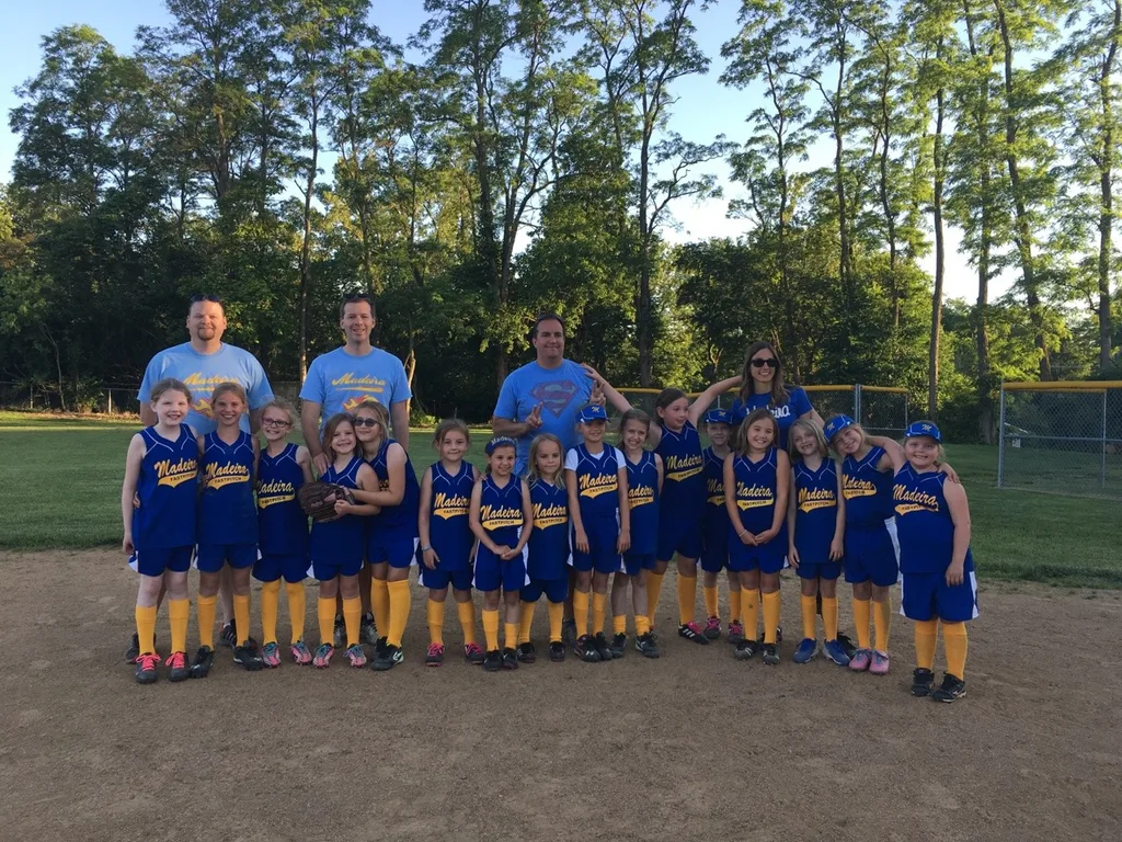 The “Pink Fluffy Curly Mustangs with Mustaches” aka Abby’s softball team and their awesome coaches