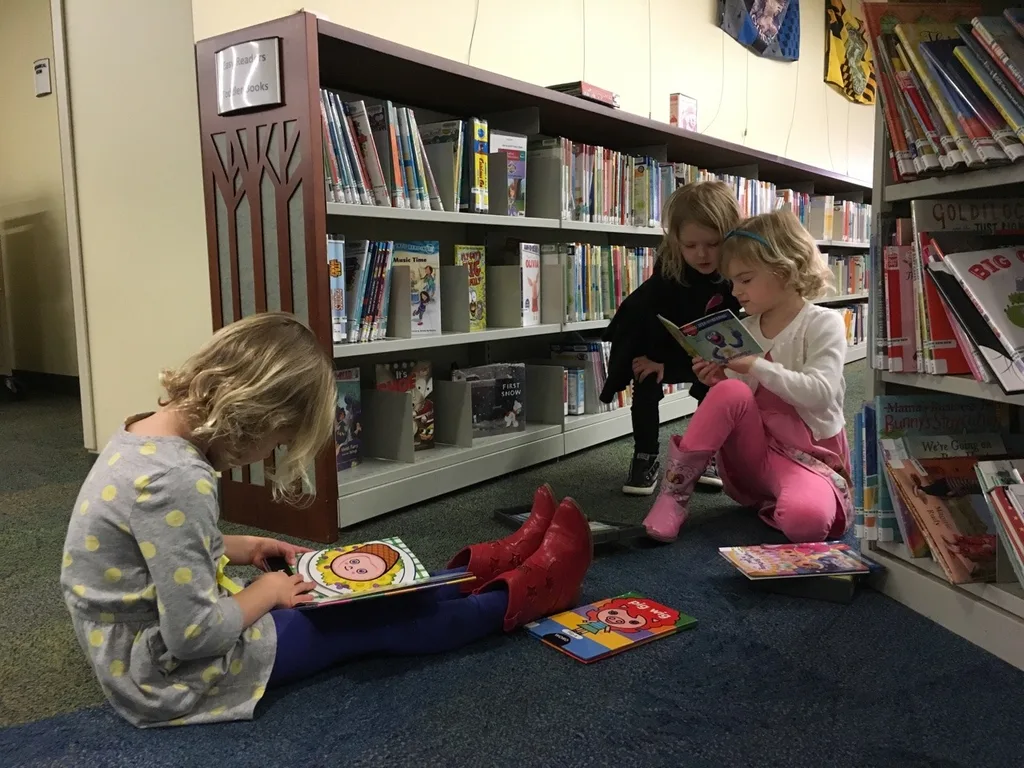 They finally have a friend at storytime (Edie) and are very interested in reading and building tall towers.