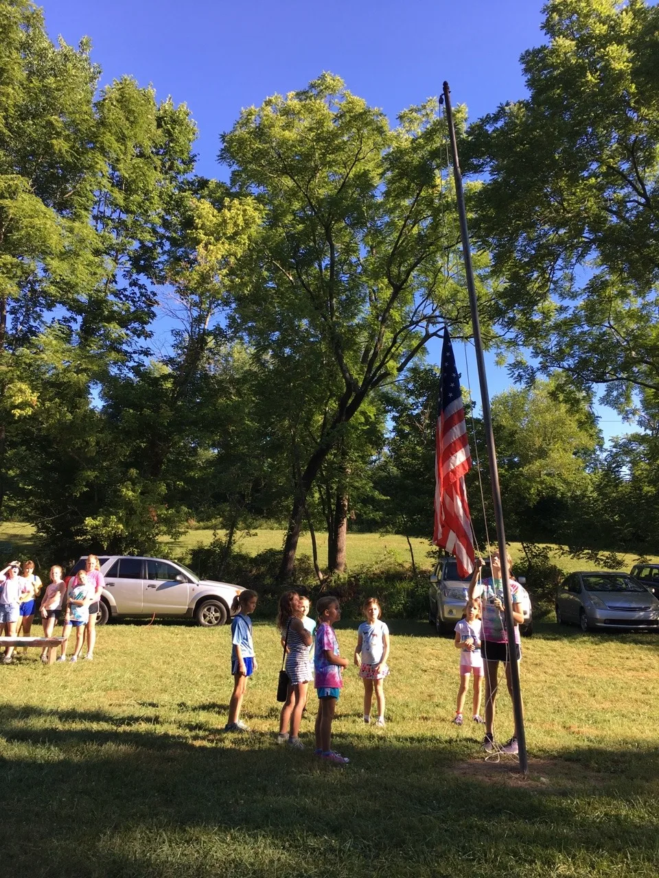 Girl Scout camp day 3 started off with our girls leading the rest of camp in the opening flag ceremony. After that, the day flew by with a talk about graphic design, cards for a service project, a nature scavenger hunt, sun s'mores, a group skit, a spider web craft, singing, creek time, hiking, and more!