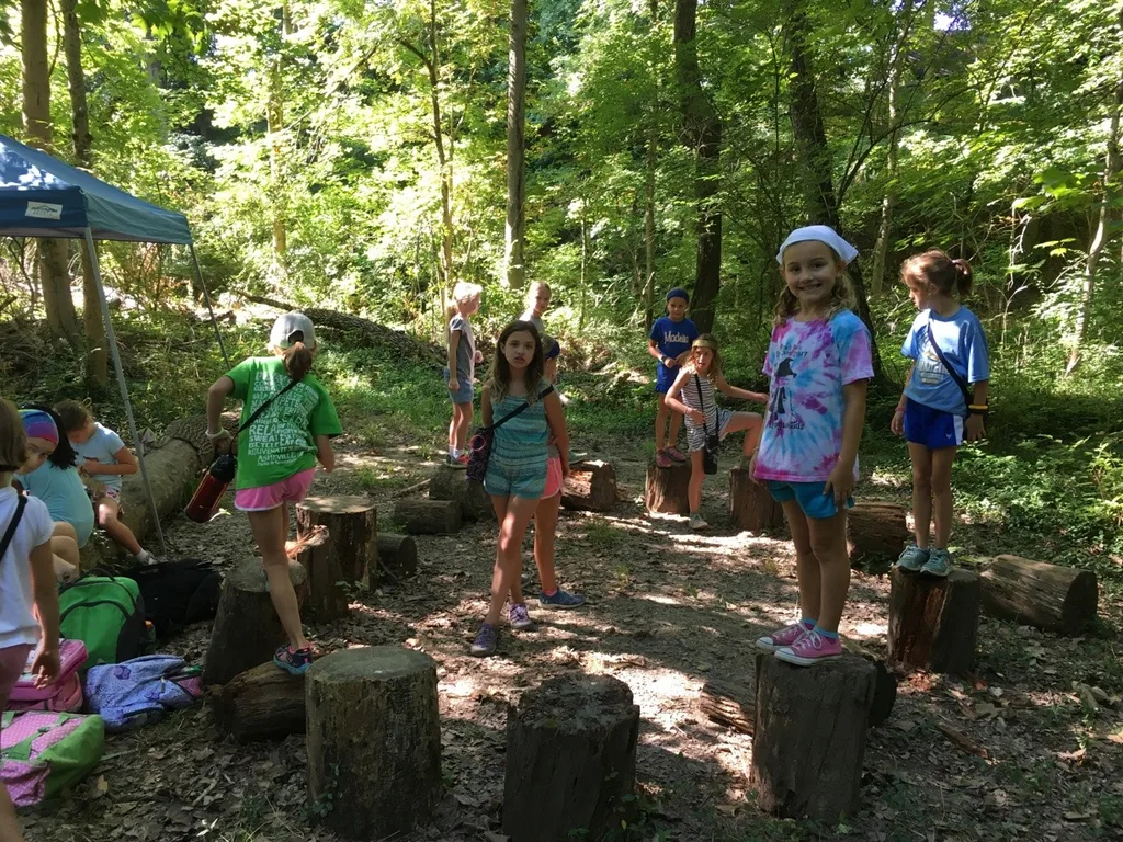 Girl Scout camp day 3 started off with our girls leading the rest of camp in the opening flag ceremony. After that, the day flew by with a talk about graphic design, cards for a service project, a nature scavenger hunt, sun s'mores, a group skit, a spider web craft, singing, creek time, hiking, and more!