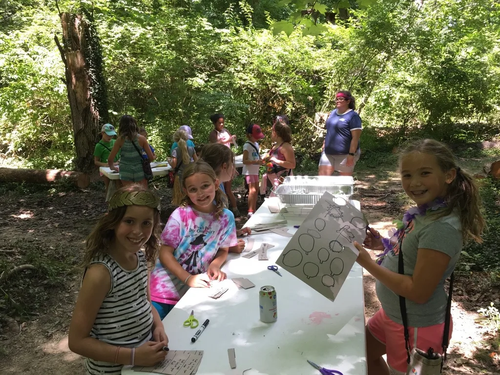 Girl Scout camp day 3 started off with our girls leading the rest of camp in the opening flag ceremony. After that, the day flew by with a talk about graphic design, cards for a service project, a nature scavenger hunt, sun s'mores, a group skit, a spider web craft, singing, creek time, hiking, and more!