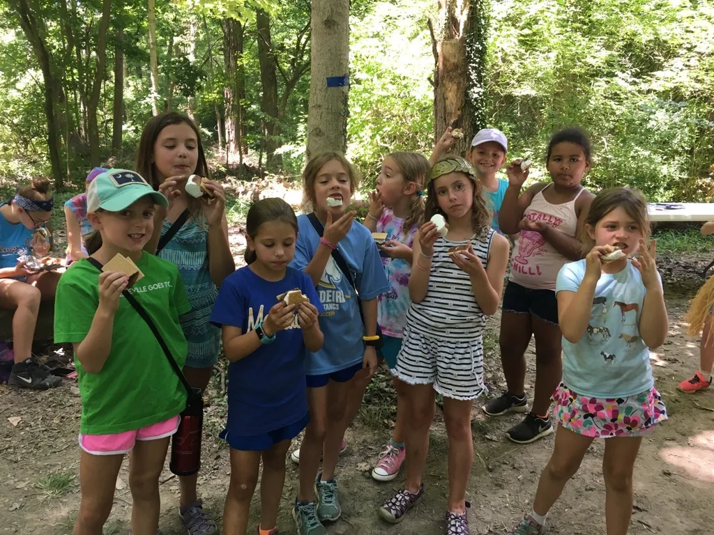 Girl Scout camp day 3 started off with our girls leading the rest of camp in the opening flag ceremony. After that, the day flew by with a talk about graphic design, cards for a service project, a nature scavenger hunt, sun s'mores, a group skit, a spider web craft, singing, creek time, hiking, and more!