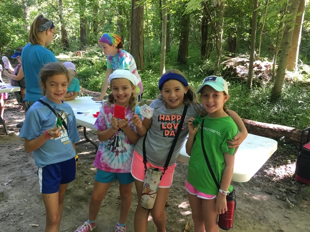 Girl Scout camp day 3 started off with our girls leading the rest of camp in the opening flag ceremony. After that, the day flew by with a talk about graphic design, cards for a service project, a nature scavenger hunt, sun s'mores, a group skit, a spider web craft, singing, creek time, hiking, and more!