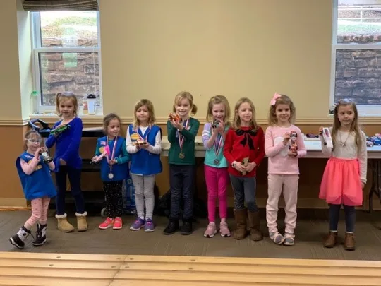 Josie’s sparkly birthday cake racer came in first place in our Daisy race of the 2019 Madeira Scouts Pinewood Derby! Abby’s Ravenclaw racer and Gwen’s rocket were both cool cars, but not quite fast enough to win (6th place).