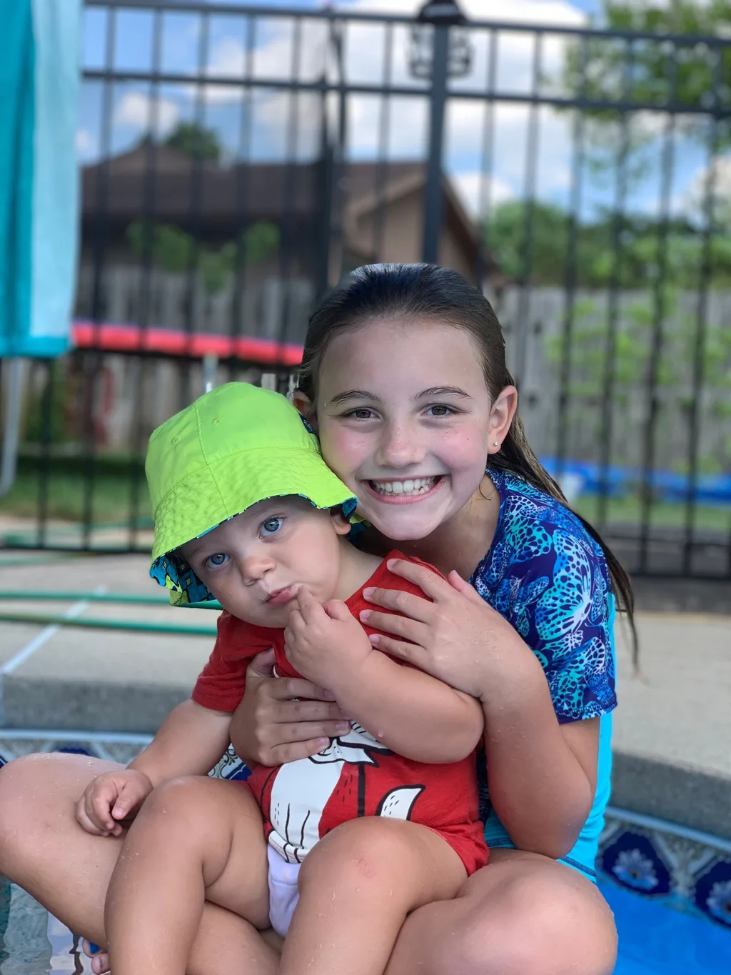 Such a fun day! We all expect a call from Timmy tomorrow to tell us how we never visit (ie he misses us). Gwen and Timmy played, and swam together a ton. Timmy can now jump in the pool from the stairs. Gwen almost convinced him to jump off the diving board. Abby, Gwen, and Timmy giggled their little hearts out while I sprayed them on the trampoline. And little Nicky is a big Abby fan. She did such a good job with him; saw a glimpse of her future as a babysitter.