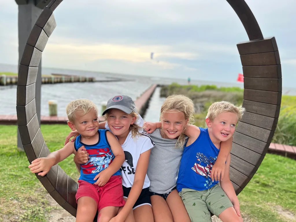 What an amazing trip to the OBX! We stayed in Salvo, one of the villages in the Cape Hatteras National Seashore. We all agreed we couldn’t have picked a better spot. The natural beauty of this place was incredible. I was amazed by the stretches of road where you could experience both the ocean and the sound at once. The waves were intense and the rip tides were terrifying, but beach walks were so nice. We loved collecting shells, hunting ghost crabs, watching the sun rise and set, splashing in the pool, watching Daisy swim, and our many excursions. Tailgating on the vehicle ferry boat ride to Ocracoke was fun. We also enjoyed jet skiing and a dolphin boat cruise from Wanchese. Watching the kite boarders while enjoying dinner at Waterman’s was a fun experience too.