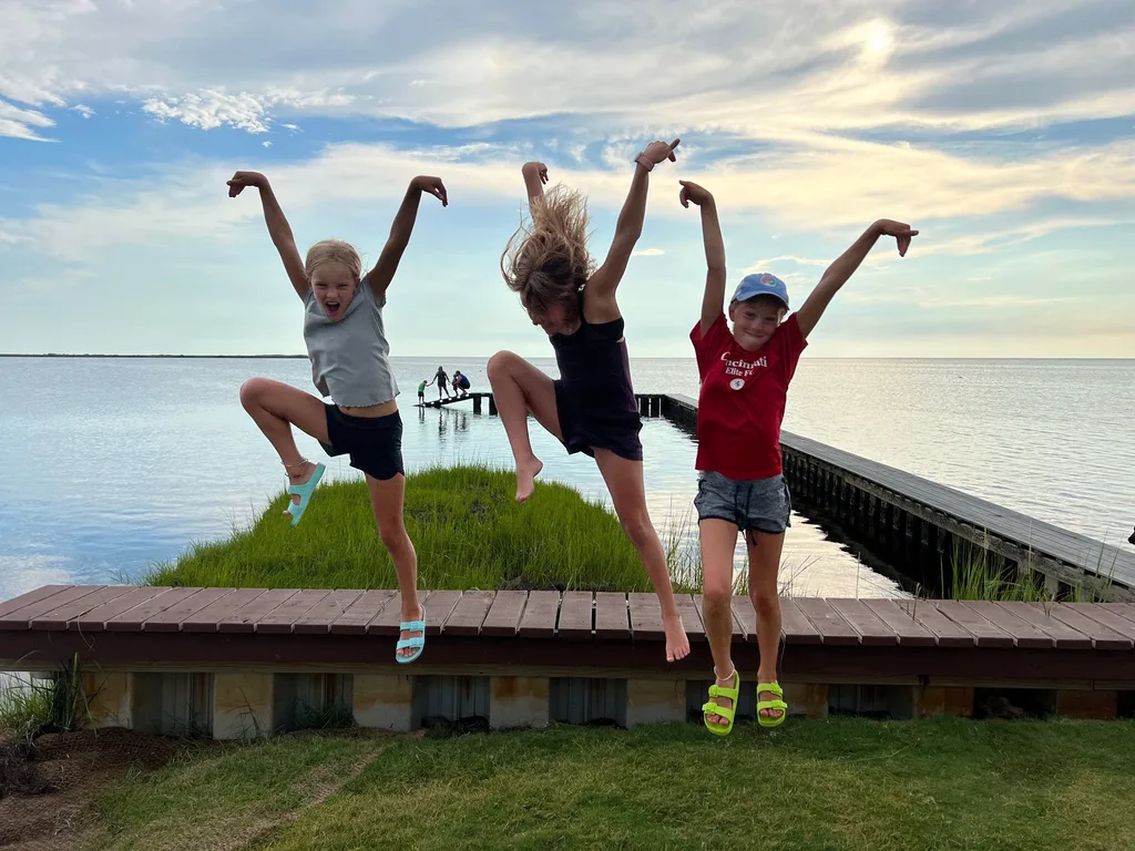 What an amazing trip to the OBX! We stayed in Salvo, one of the villages in the Cape Hatteras National Seashore. We all agreed we couldn’t have picked a better spot. The natural beauty of this place was incredible. I was amazed by the stretches of road where you could experience both the ocean and the sound at once. The waves were intense and the rip tides were terrifying, but beach walks were so nice. We loved collecting shells, hunting ghost crabs, watching the sun rise and set, splashing in the pool, watching Daisy swim, and our many excursions. Tailgating on the vehicle ferry boat ride to Ocracoke was fun. We also enjoyed jet skiing and a dolphin boat cruise from Wanchese. Watching the kite boarders while enjoying dinner at Waterman’s was a fun experience too.